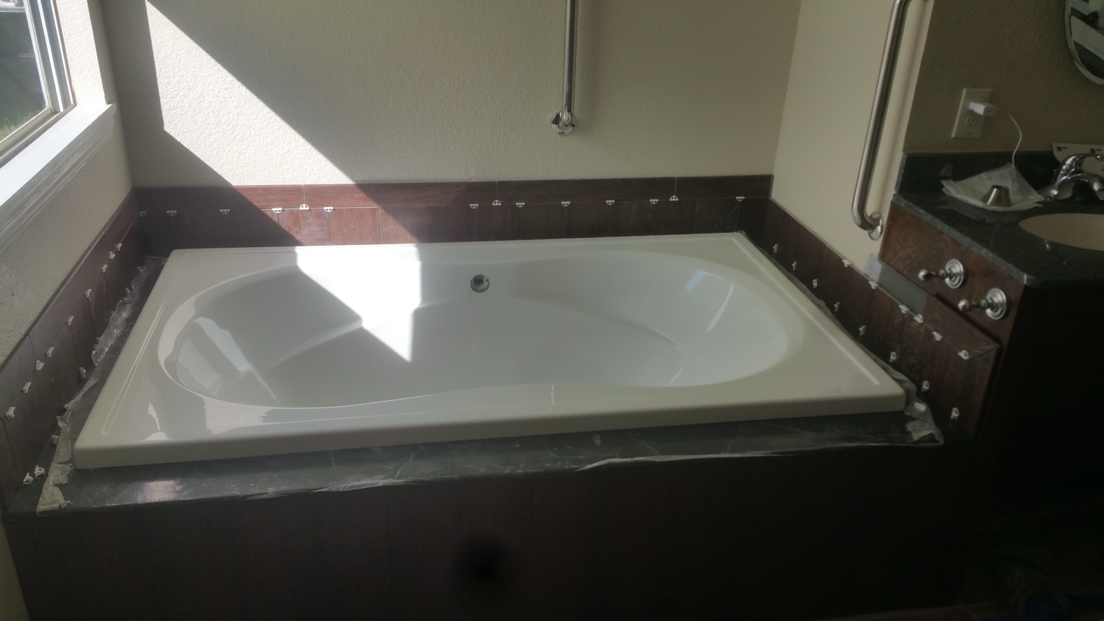 Garden tub set into a wood surround