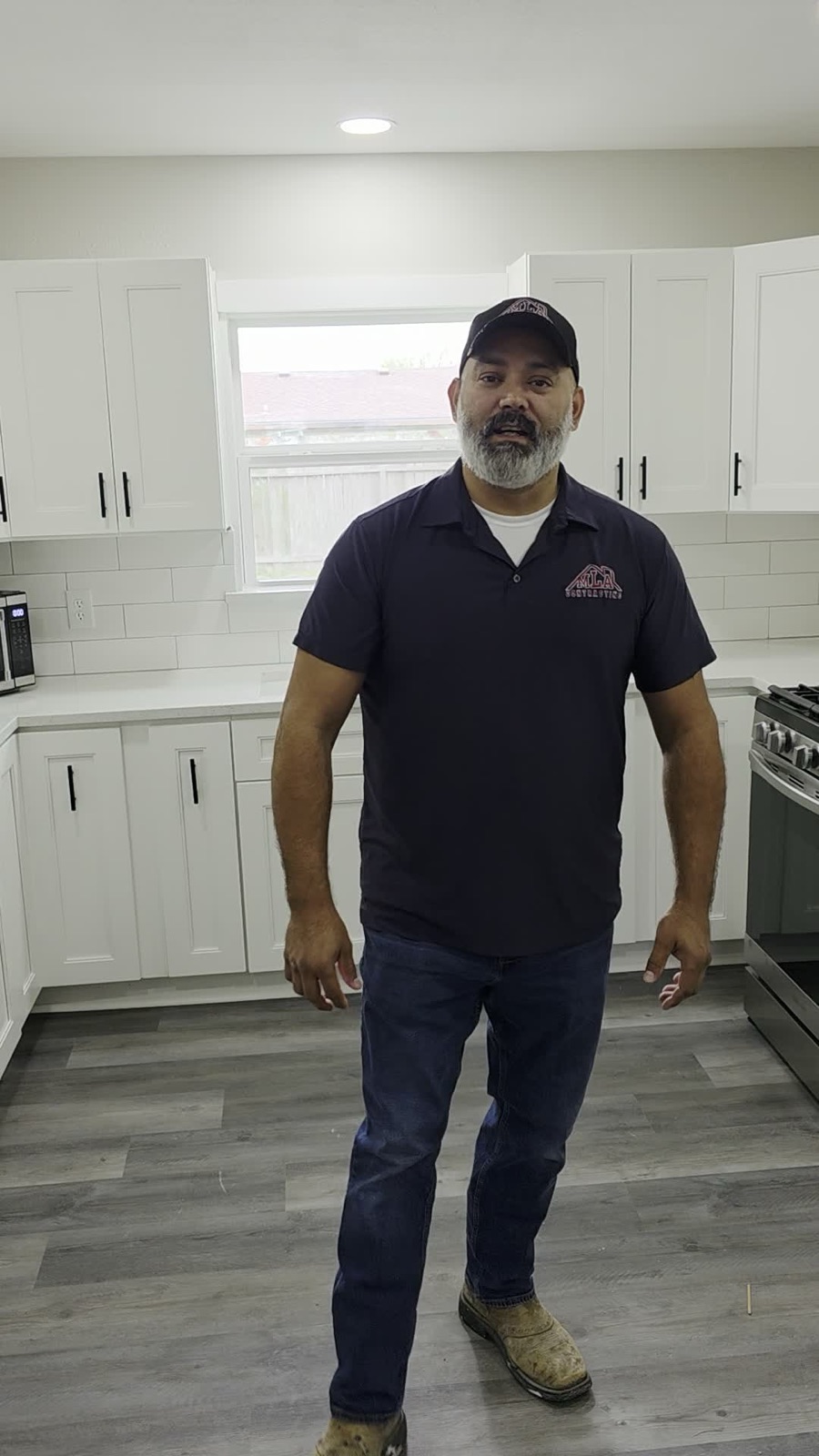 Juan Martinez, owner of MLA Contracting, standing in a finished kitchen remodel